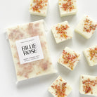 packet of wax melts and loose wax melts decorated with dried botanicals