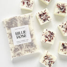 packet of wax melts and loose wax melts decorated with dried botanicals