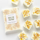 packet of wax melts and loose wax melts decorated with dried botanicals