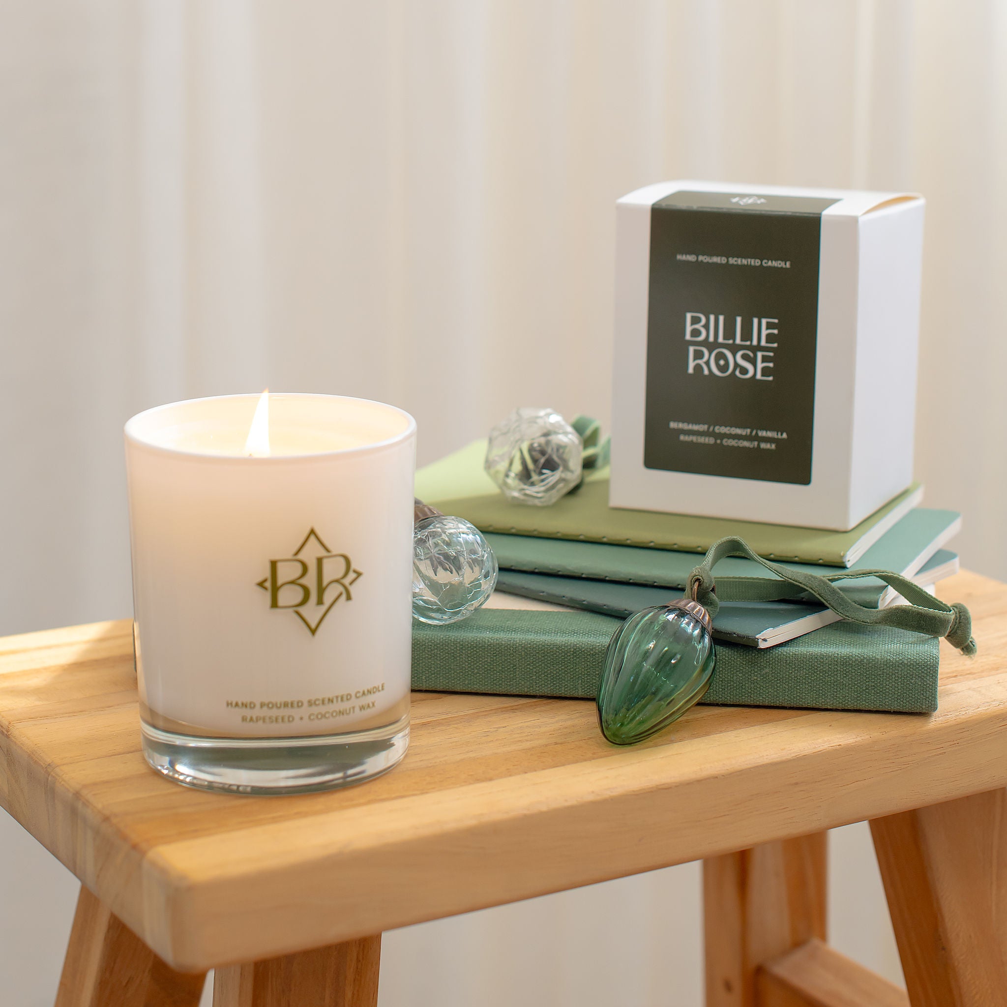 lit candle and box  surrounded by christmas decorations